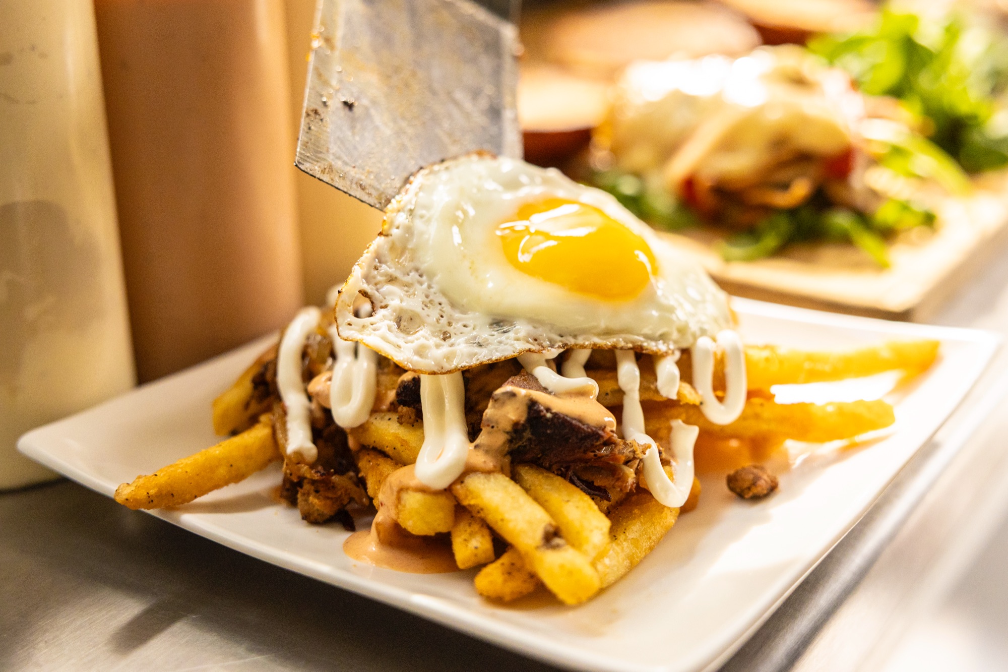 Chorrillana piled with fries, brisket, chorizo and fried egg